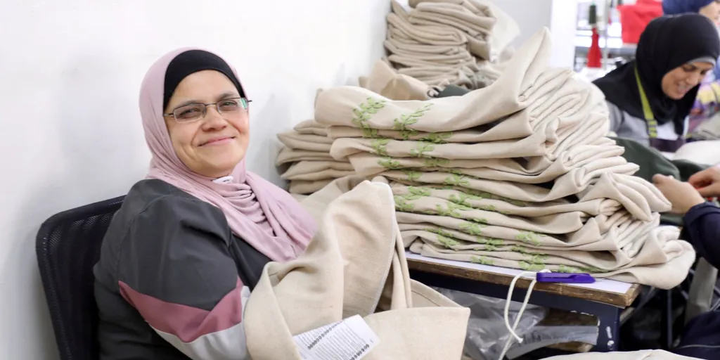 Refugee and Jordanian women sew cushion covers at a JRF run workshop in downtown Amman which will be sold at IKEA