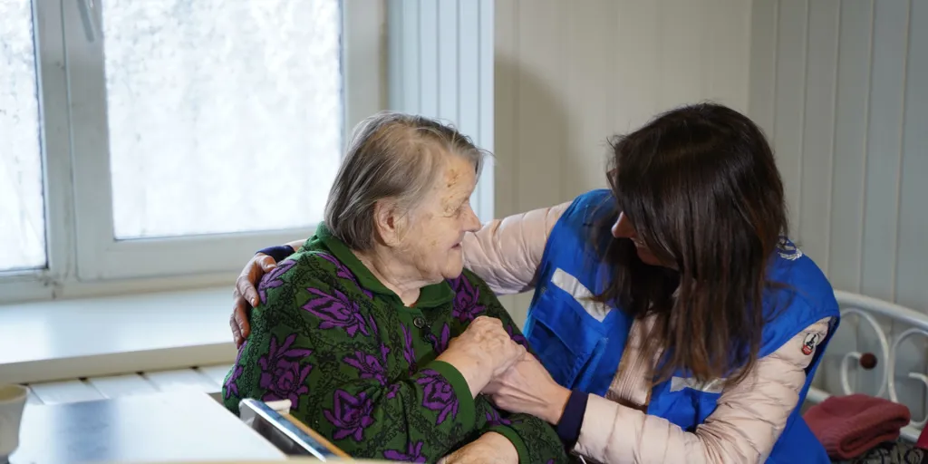 UNHCR assists a woman who was forced from her home in Ukraine