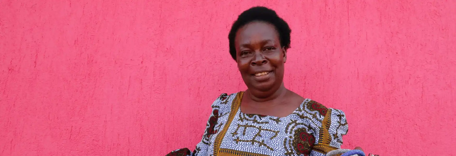 cta_uganda_congolese-woman-holds-brightly-coloured-handicrafts