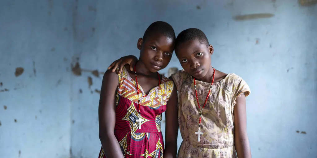 Congolese refugee sisters embrace inside their home in Nakivale settlement, Uganda. Uganda hosts around one million refugee children.