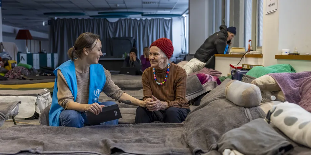 UNHCR protection monitor Svetlana Lokian is conducting an interview with Valentina