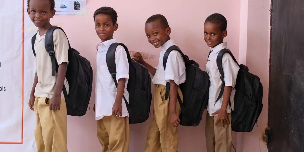 A group of Somali refugee school kits stand with their new back to school kits