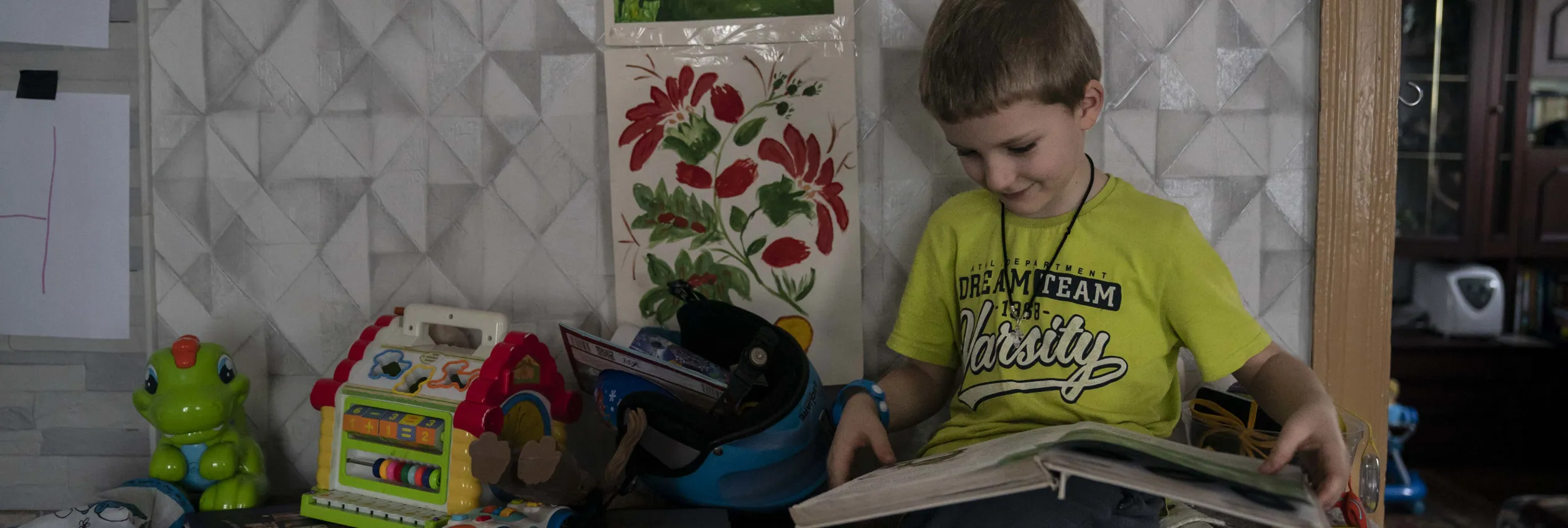 Ukraine_Ivan-5-looks-at-book-in-great-grandparents-home