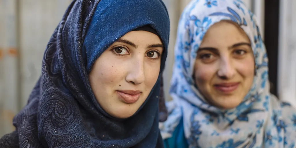 Two Syrian refugee sisters in the family's shelter in Zaatari refugee camp in Jordan