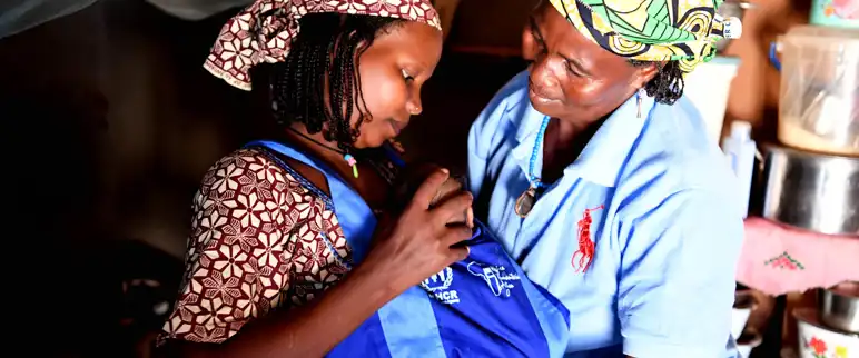 Cameroon A Woman Help Her Daughter In Law With The Kangaroo Scarf