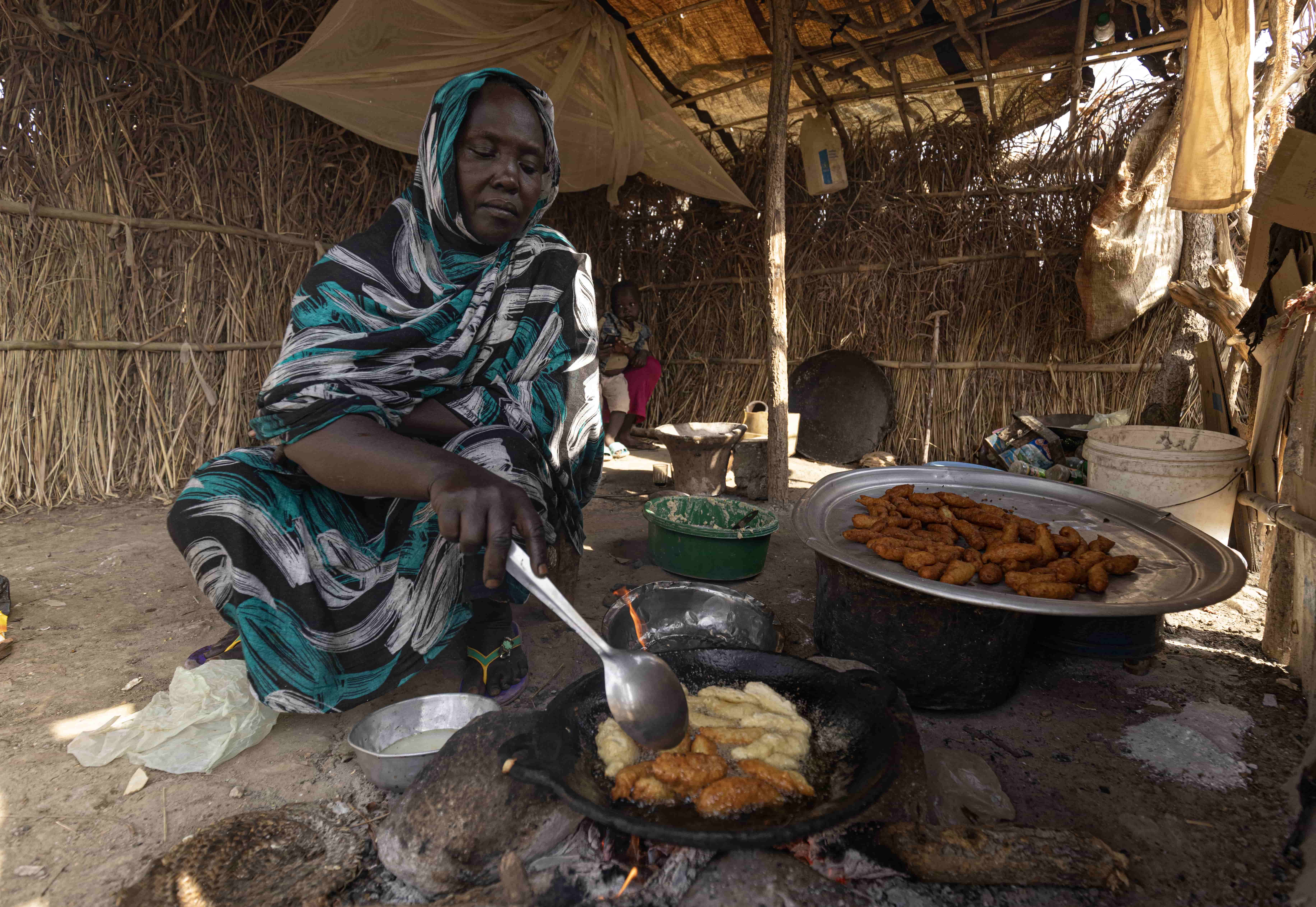 Ethiopia. Hawa cooks falafel which she sells to buy soap and food for her children.