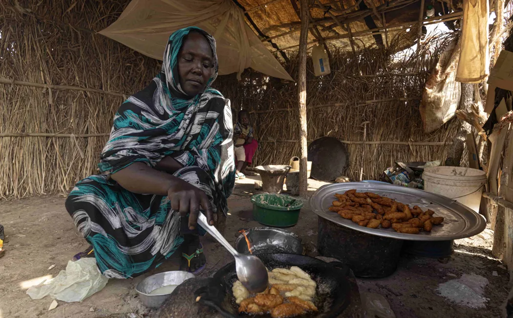 Ethiopia. Hawa cooks falafel which she sells to buy soap and food for her children.